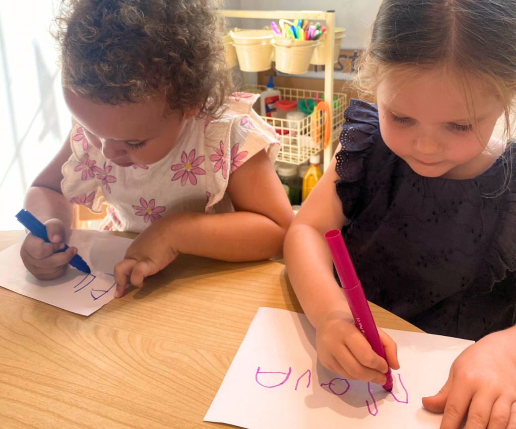 Picture of two girls writing for World Writing Day.